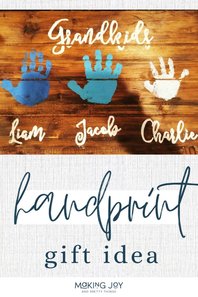 Wooden sign with kids handprints painted on it with names with text overlay that says handprint gift idea