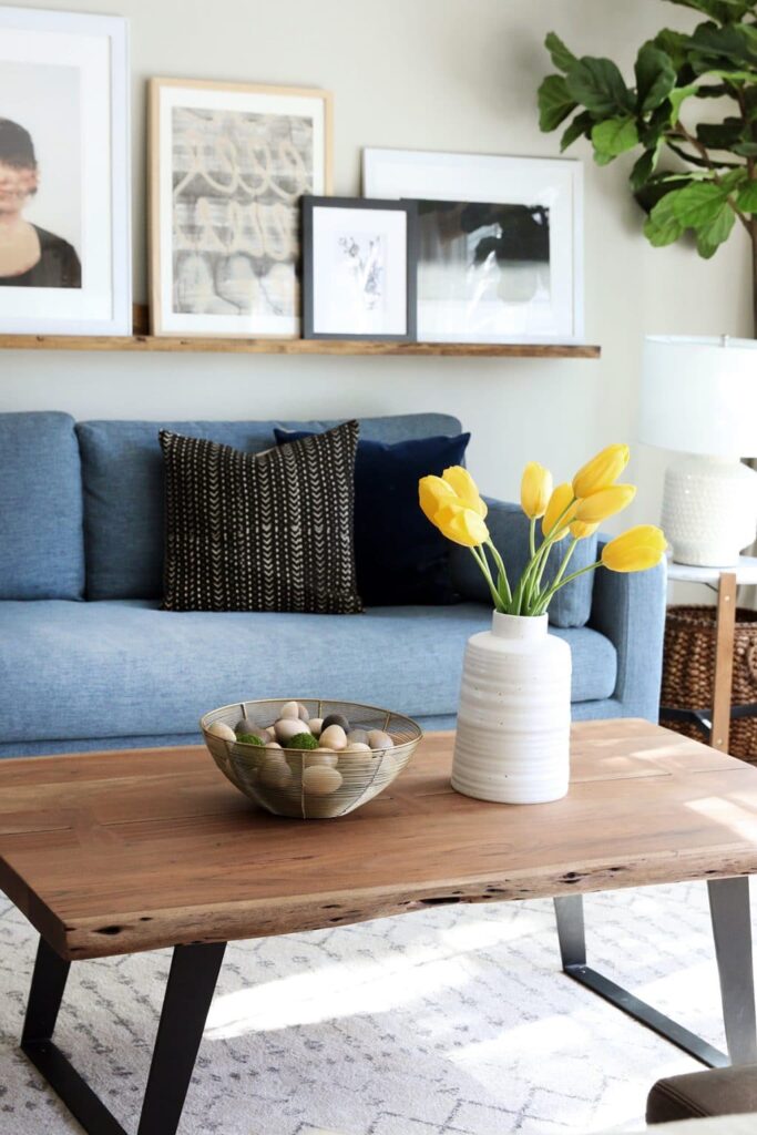 A photo of wooden eggs in a bowl on the coffee table.
